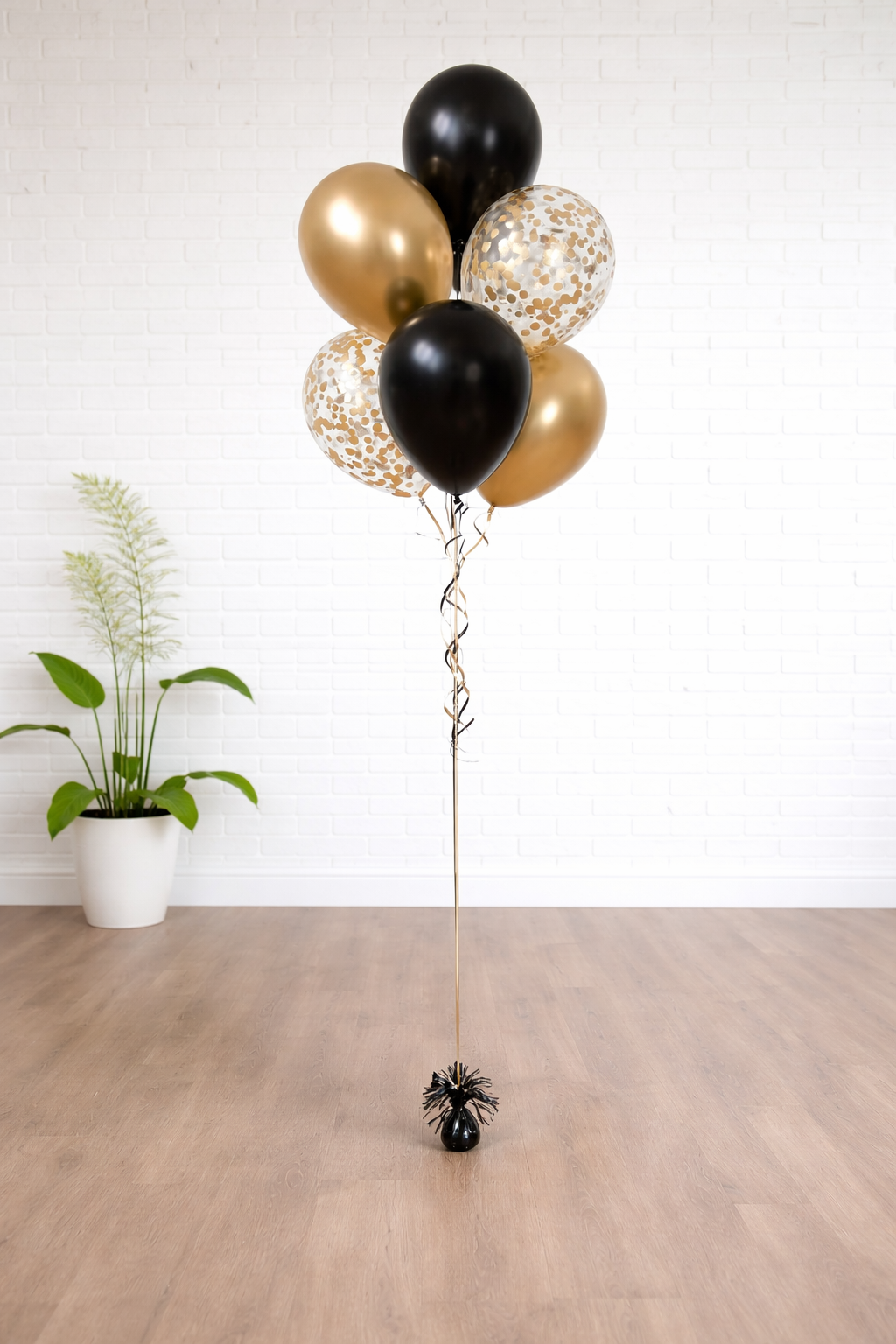 Confetti celebration balloon bouquet with black and gold balloons for New Year party in Augusta GA
