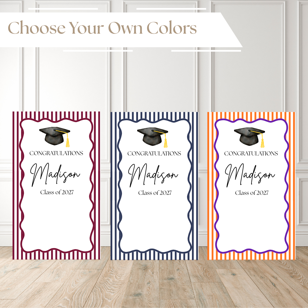 Three graduation-themed label designs displayed side by side on a light wood floor against a white paneled wall. The top banner reads 'Choose Your Own Colors.